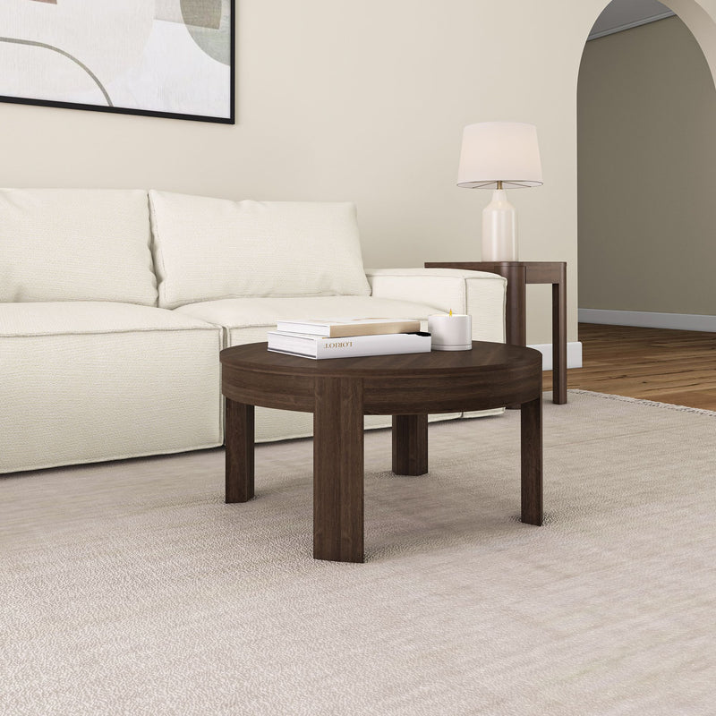 Stylish modern living room with white sofa, dark wood coffee table, beige rug, and soft ambient lighting.