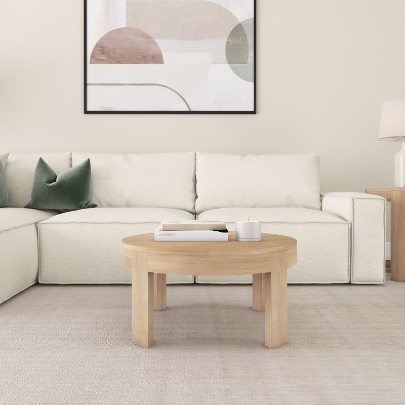 Modern living room with beige sectional sofa, wooden coffee table, and abstract wall art.