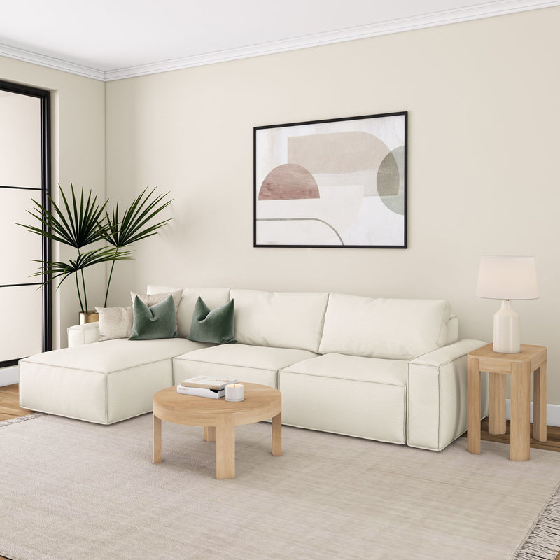 Elegant living room with modern sectional sofa, wooden coffee table, and minimalist decor, featuring abstract art and indoor plant.