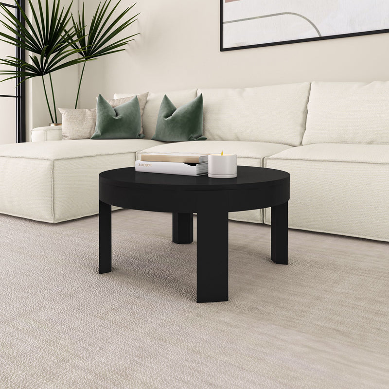Modern living room with a white sectional sofa, black round coffee table, and decorative pillows in a stylish contemporary design.