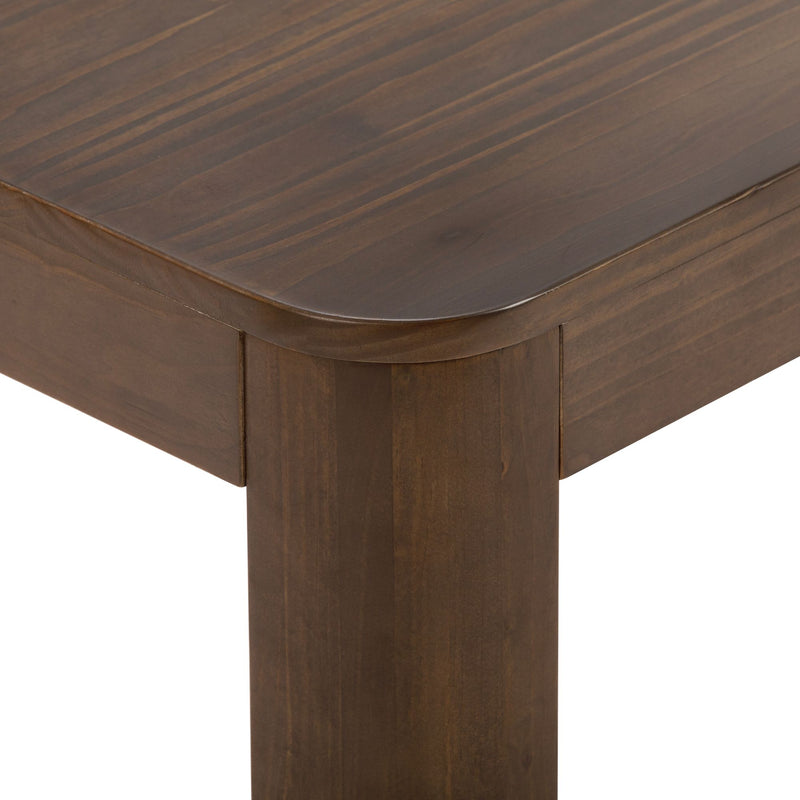 Close-up of a brown wooden table corner showing elegant craftsmanship and smooth finish.