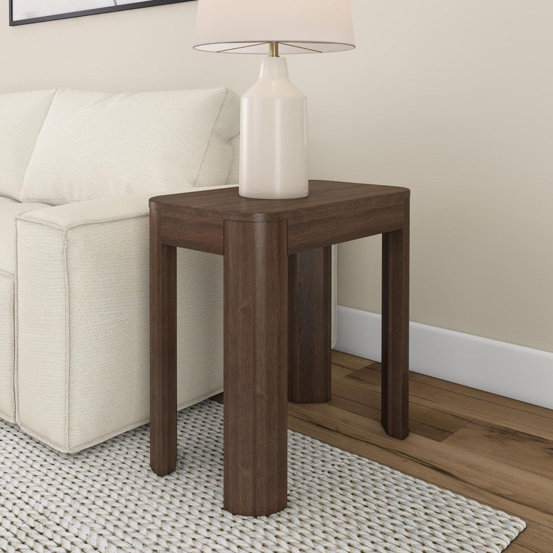Modern wooden side table with lamp next to white sofa, perfect for living room decor.