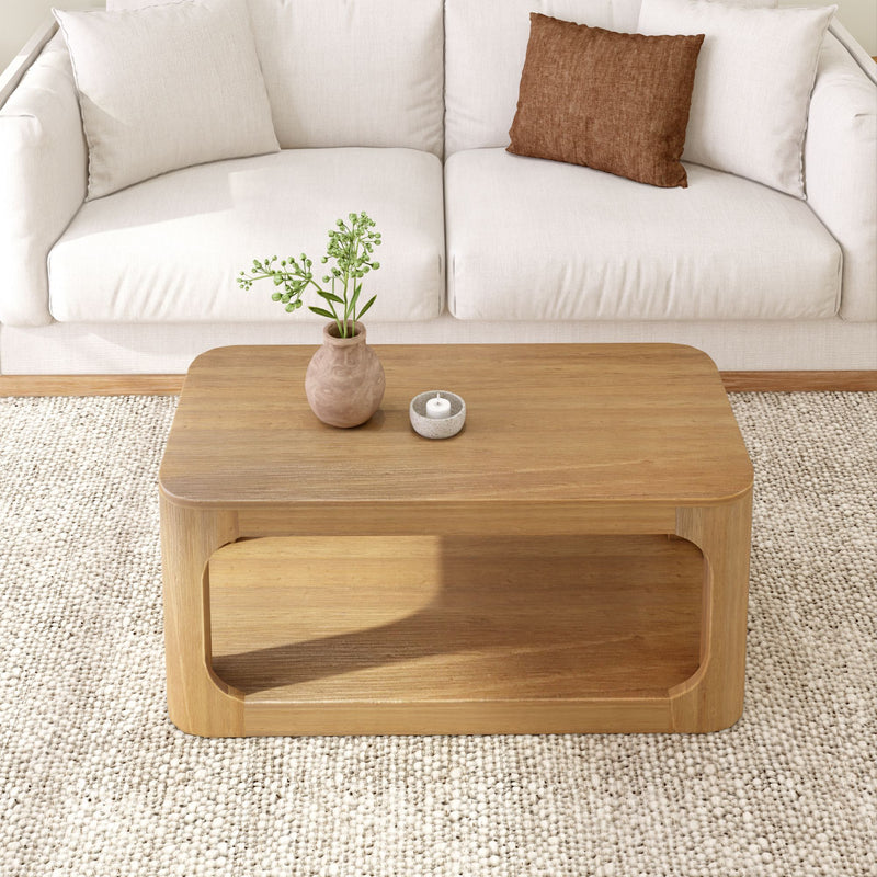 Wooden coffee table in modern living room with white sofa and decorative plants.