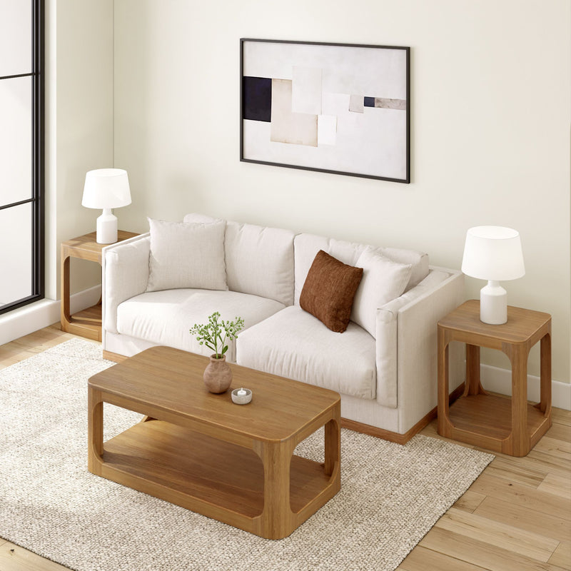 Modern living room with a beige sofa, wooden coffee table, and decorative lamps on side tables.