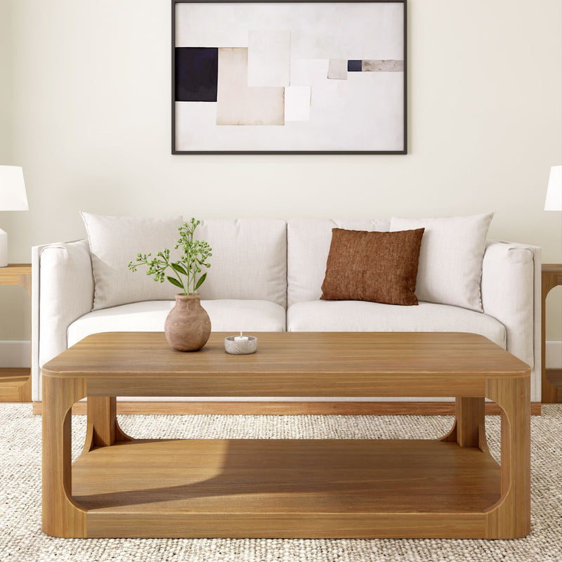 Modern living room with a white sofa, wooden coffee table, abstract art, and minimalist decor.