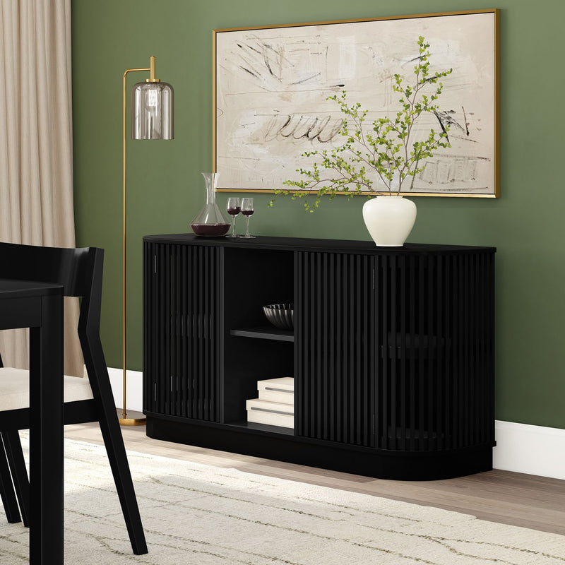 Modern black sideboard with decorative vase and wine glasses against green wall in elegant dining room.
