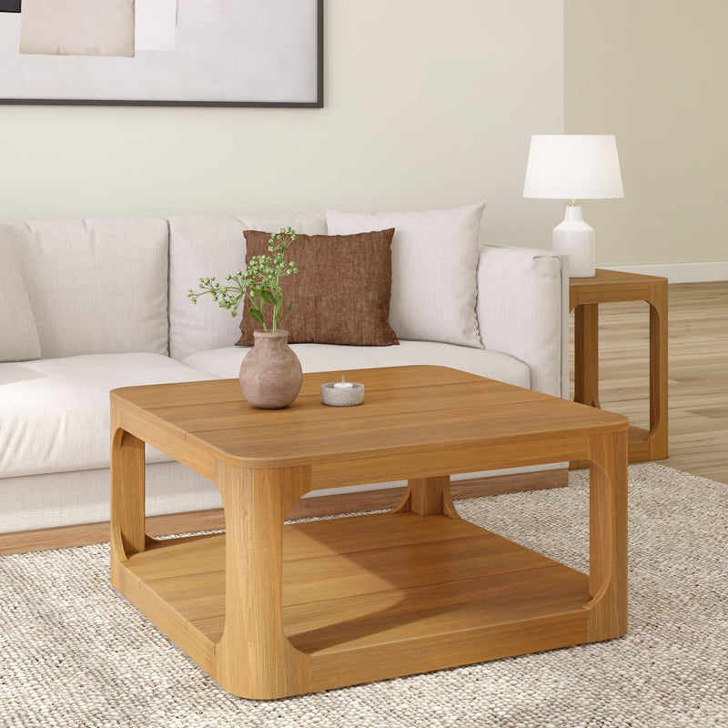 Modern living room with wooden coffee table, white couch, and decorative elements.