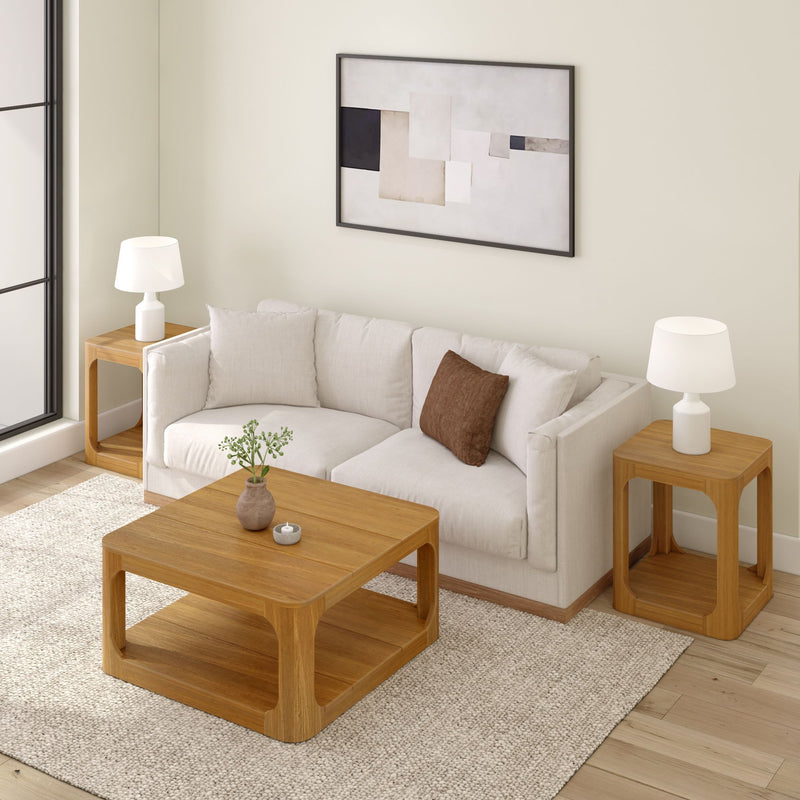 Modern living room with a beige sofa, wooden coffee table, and side tables, featuring abstract wall art and soft lighting.