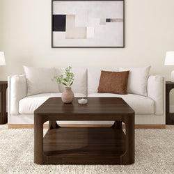 Modern living room with white sofa, dark wood coffee table, and abstract wall art.