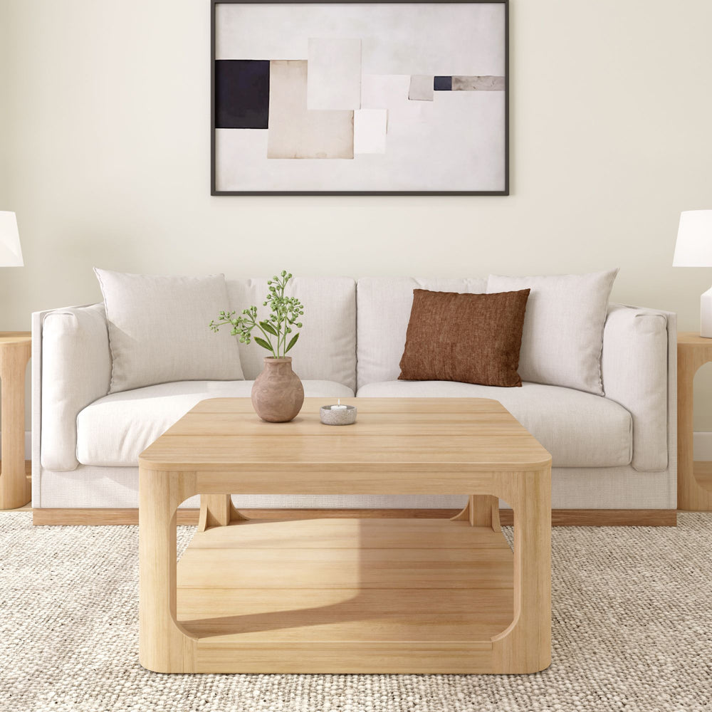 Modern living room with a beige sofa, wooden coffee table, and abstract wall art.