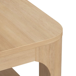 Rounded corner of a modern wooden table with a light finish.