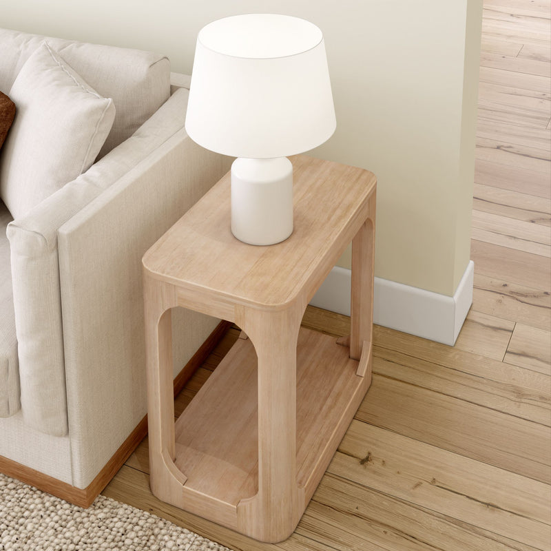 Modern minimalist wooden side table with white lamp next to beige sofa in living room.