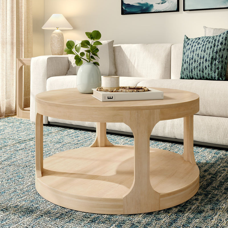 Modern living room with a round wooden coffee table, cozy beige sofa, decorative pillows, and a stylish blue rug.