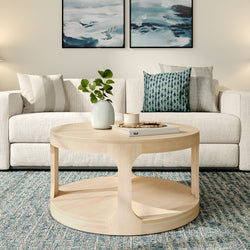 Modern living room with beige sofa, rustic wooden coffee table, and abstract wall art decor.