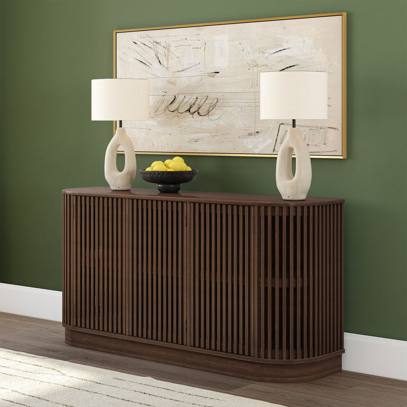 Elegant wooden sideboard with slatted design, adorned with modern table lamps and a decorative bowl of lemons, set against a green wall and abstract art.