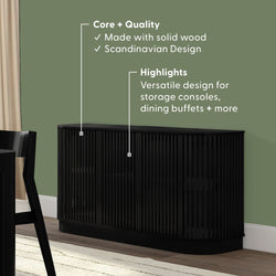 Black solid wood Scandinavian sideboard with vertical slatted doors and curved edges against green wall, modern storage console and dining buffet for living room