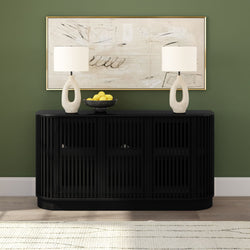 Black slatted storage console table with two white ceramic lamps, bowl of lemons and abstract framed art on green accent wall, minimalist entryway decor