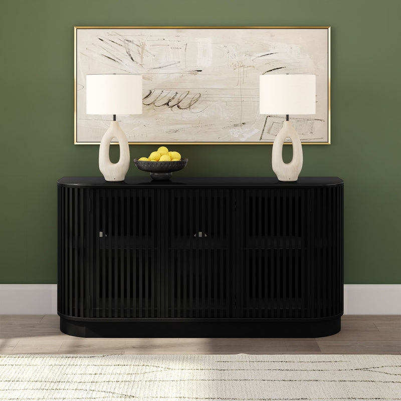 Black slatted storage console table with two white ceramic lamps, bowl of lemons and abstract framed art on green accent wall, minimalist entryway decor