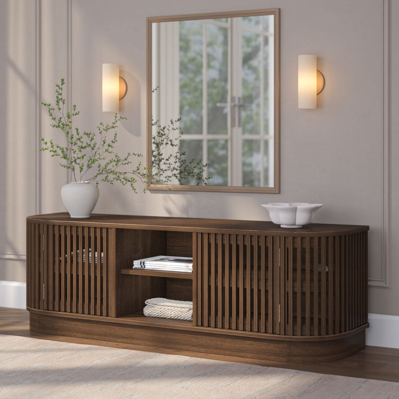 Modern wooden sideboard with mirror, decorative vase, and lighting fixtures in elegant room setting.