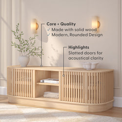 Rounded wooden sideboard with slatted doors, highlighting modern design and acoustical clarity, in a stylish living room setting.