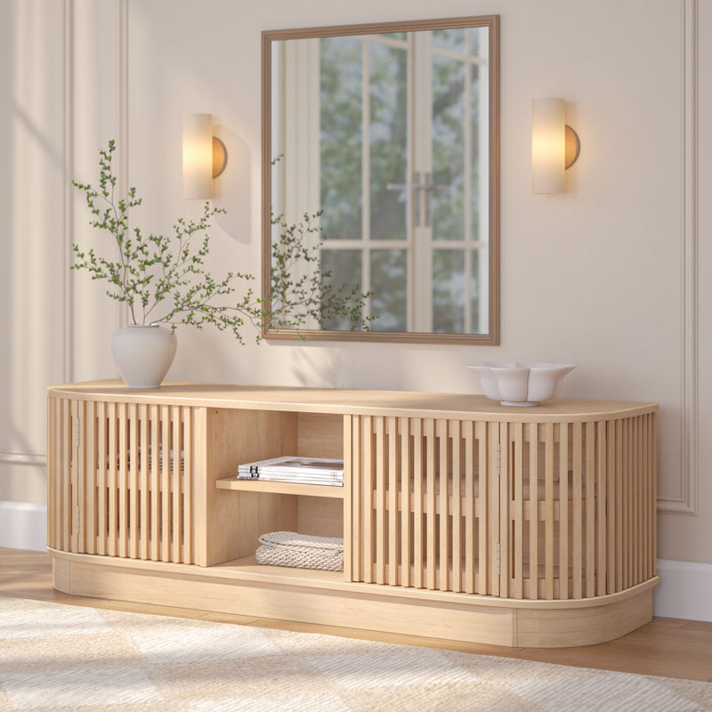 Modern wooden sideboard with decorative vase, mirror, and soft lighting in elegant living room setting.
