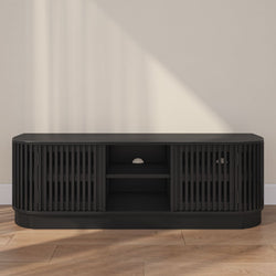 Black wooden media console table with shelving and cabinet doors in a modern living room setting.