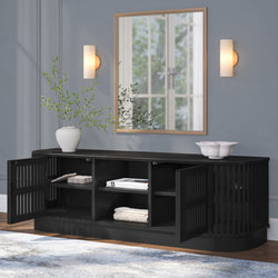 Modern black sideboard with open doors, decorative white vase, and indoor plants in elegant living room setting.