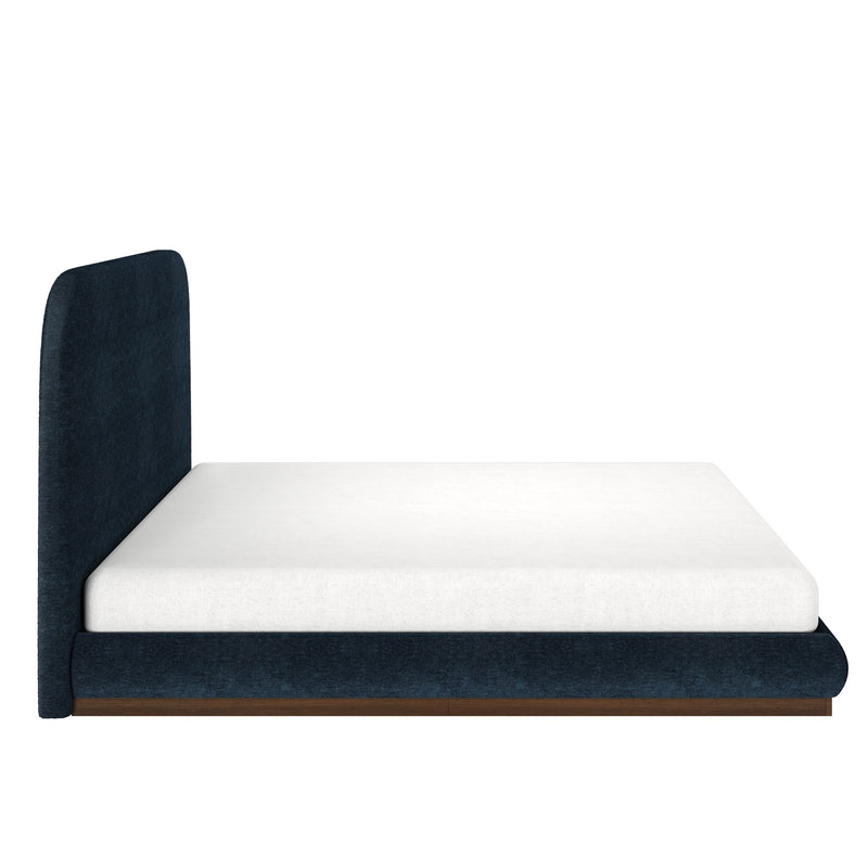 Modern platform bed with blue upholstered frame and white mattress.
