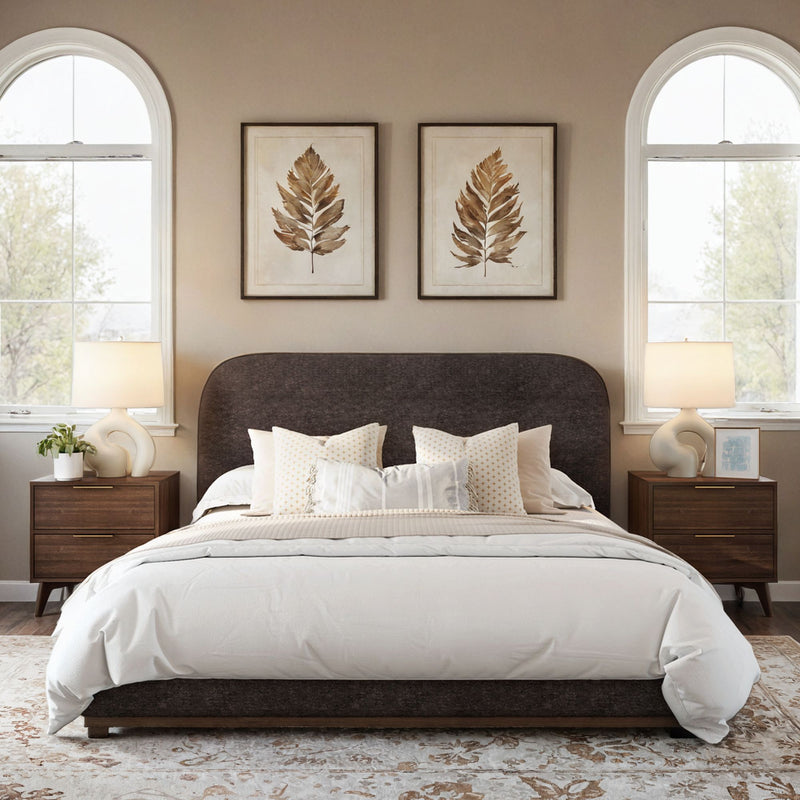 Contemporary bedroom with stylish decor, featuring a cozy bed, wooden nightstands, elegant lamps, and framed leaf artwork.