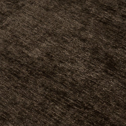 Close-up of dark brown velvet upholstery fabric texture with soft plush pile, ideal for sofas, cushions, and area rugs