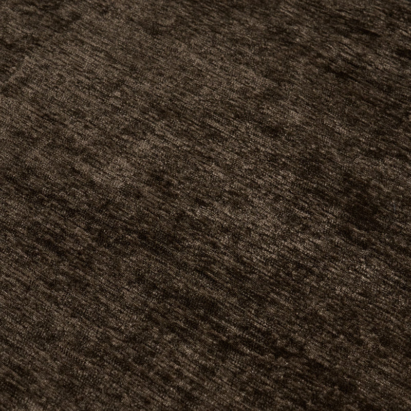 Close-up of dark brown velvet upholstery fabric texture with soft plush pile, ideal for sofas, cushions, and area rugs
