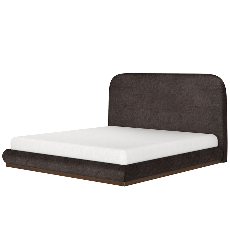 Modern low-profile bed with dark fabric headboard and white mattress.