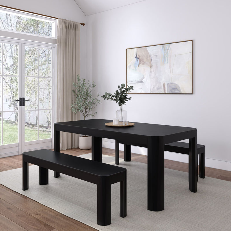 Modern black dining table set with benches in a bright, minimalist dining room.