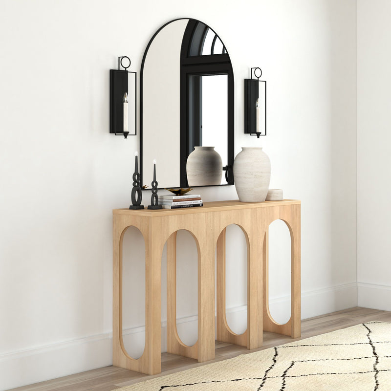 Elegant modern console table with decorative mirror and vases in stylish home interior.