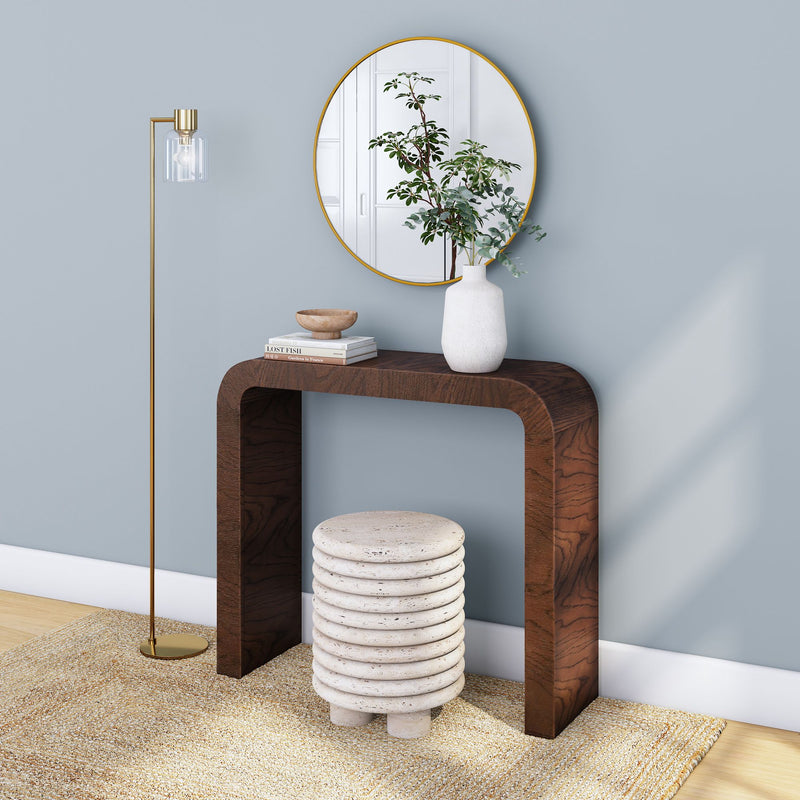 Minimalist living room decor with a modern wooden console table, round mirror, white ceramic vase, and gold floor lamp.