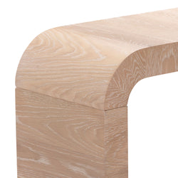 Close-up of light whitewashed oak wood bench corner with rounded edge and visible wood grain, modern minimalist furniture