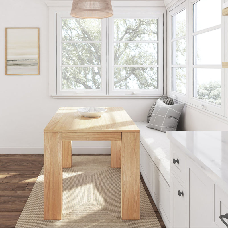 Bright kitchen nook with wooden dining table, corner bench seating, and large windows providing natural light.