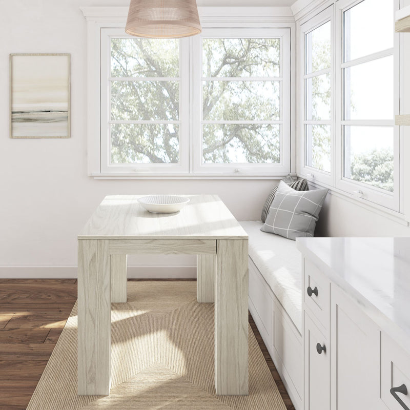 Bright corner dining nook with wooden table, cushioned bench seating, and large windows showcasing natural light.