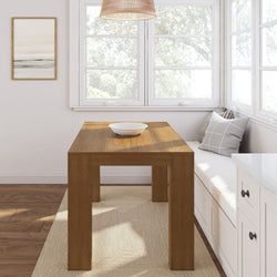 Minimalist dining area with a wooden table, modern seating, and large windows for natural lighting.