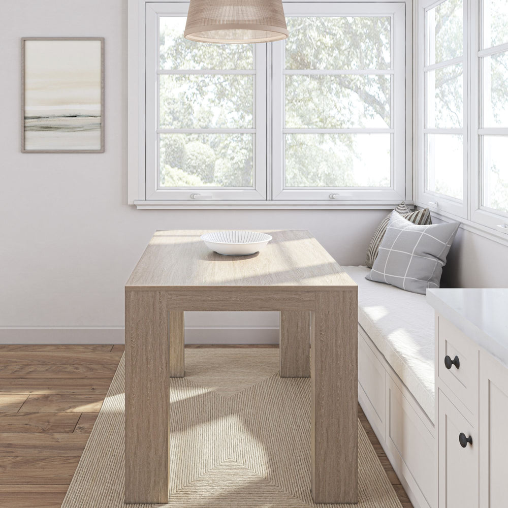 Cozy modern breakfast nook with wooden table and bench seating against large windows.