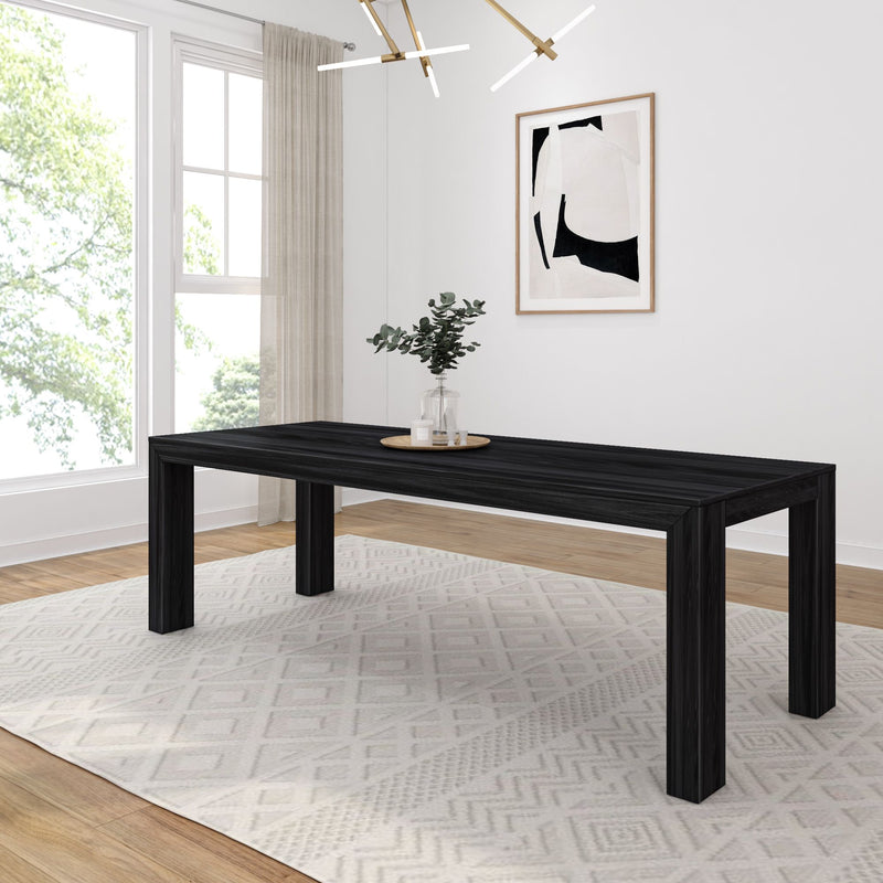 Black modern dining table with minimalist decor in a bright, contemporary dining room.