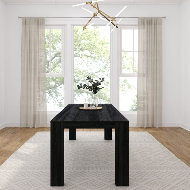 Modern dining room with sleek black table, contemporary chandelier, and natural light through large windows.