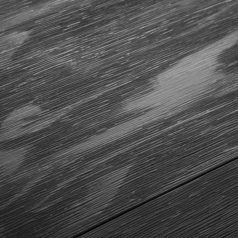 Textured dark wood surface with horizontal grain pattern.
