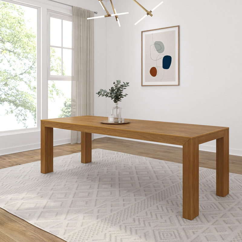 Modern dining room with wooden table, geometric rug, and abstract wall art.