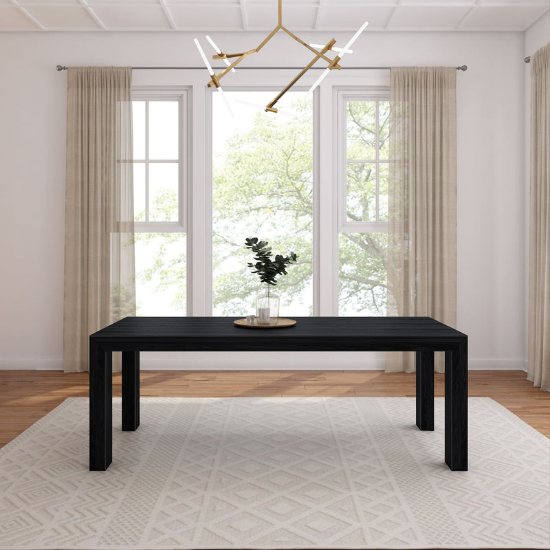 Modern dining room with a sleek black table, minimalist decor, and natural light.