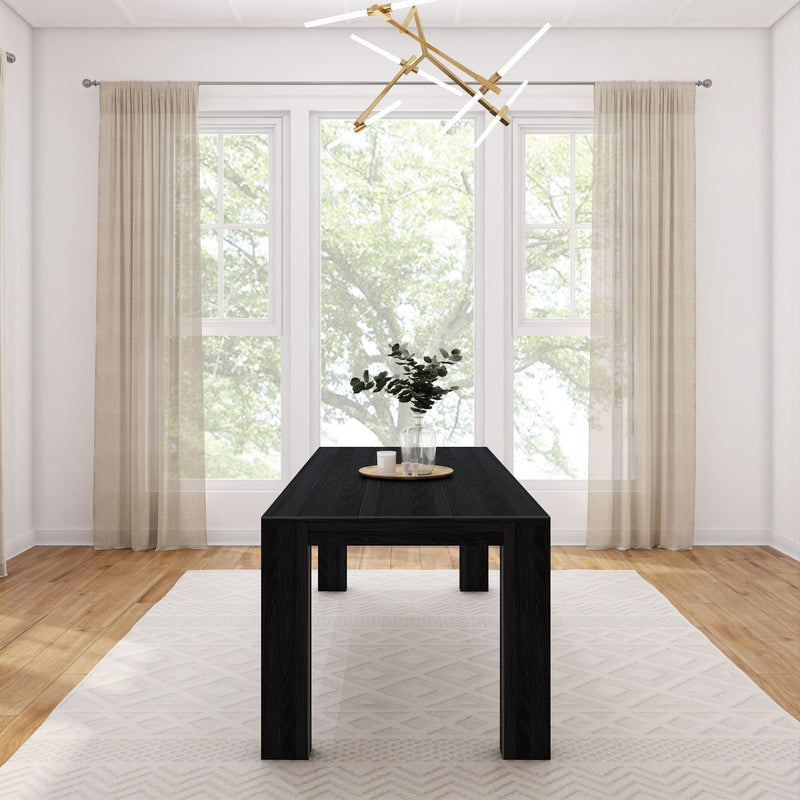 Minimalist dining room with black table, light beige curtains, and modern chandelier.