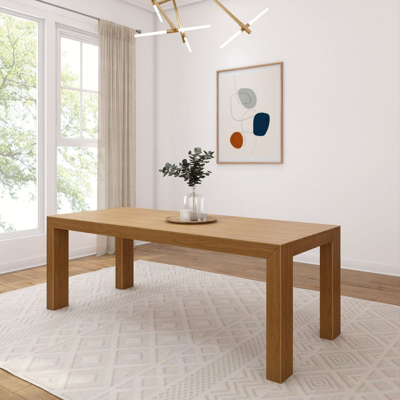 Modern wooden dining table in a bright minimalist room with large window, rug, and abstract wall art.