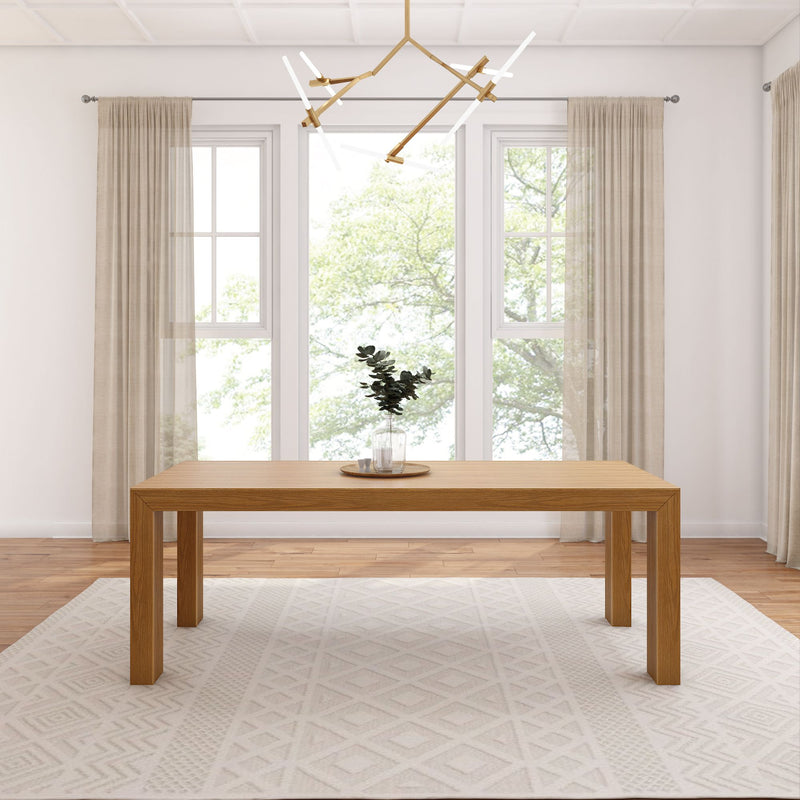 Modern dining room with minimalist wooden table, geometric rug, and unique ceiling light fixture.