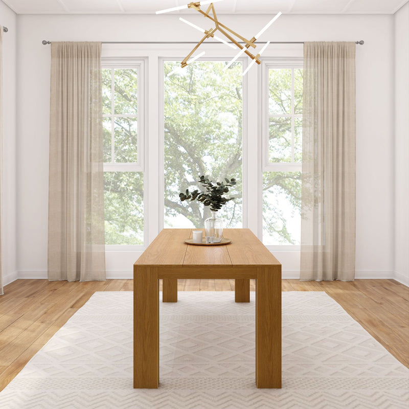 Modern dining room with a minimalist wooden table, large windows, beige curtains, and contemporary lighting fixture.