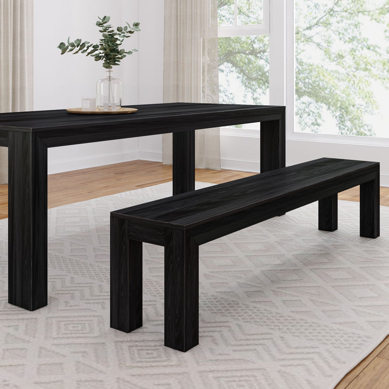 Modern black dining table set with bench in bright room with large windows and white curtains.